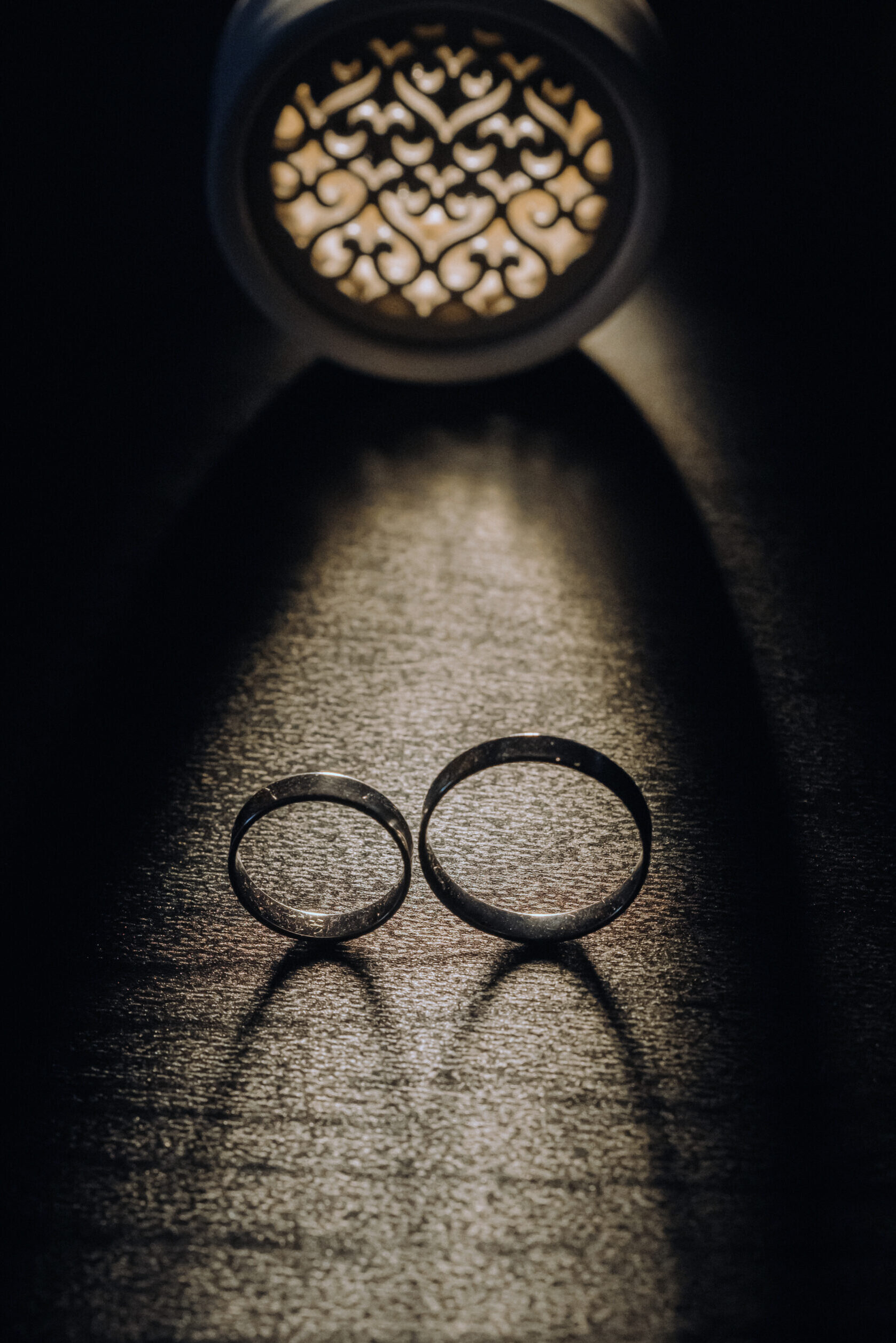 Home close up of two gold wedding rings on a black background
